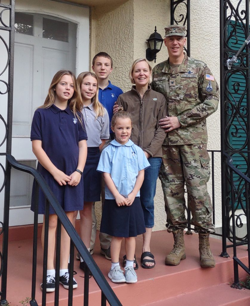 The Ojala family posing together on their front doorstep